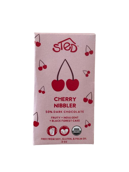 Box of Sted Cherry Nibbler dark chocolate on a white background
